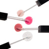 Four lip gloss applicators arranged diagonally, each displaying a different color: soft pink, vibrant pink, mauve, and clear with sparkles, showcasing diverse shade options.