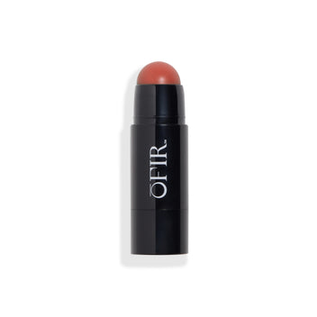 Cream blush stick in a black tube, revealing a rounded blush tip in a brick brown shade. Blank background