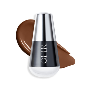 OFIR foundation bottle with a swatch of a deep cool nude-colored liquid foundation on a blank background