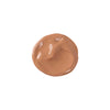 medium/tan shade liquid swatch of tinted moisturizer, smooth texture with a glossy finish