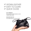 Benefits banner for Cinch Bag. Text highlights the product’s features: “Vegan Leather,” “Easy to Clean,” and “Quick Close.” Additional descriptions include “Eco Friendly. Soft, wipeable material means no more makeup bag messes” and “Gather and Go. It's the ideal size for on-the-go basics”