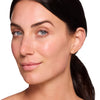 Model showcasing a radiant complexion with smooth, glowing skin and subtle natural makeup.