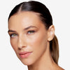 Model showcasing a natural but enhance brow design and control in a radiant natural makeup look.