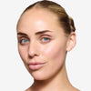 Model showcasing a natural but enhance cool brown brow design and color in a radiant natural makeup look.