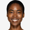 Model showcasing a deep shade of tinted moisturizer