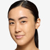 Model showcasing a light shade of tinted moisturizer