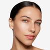 Model showcasing a medium shade of tinted moisturizer