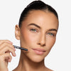 Model holding and showcasing a light pink lip liner