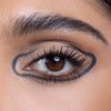 Close-up of a well-defined eye with bold eyeliner outlining the eyelid, enhancing the brown eye color and neatly groomed eyebrow, perfect for a dramatic makeup look.