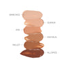 A vertical array of foundation swatches in various shades, labeled from top to bottom: Bare Rice, Quinoa, Rye, Papyrus, Millet, and Allspice.