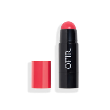 Cream blush stick with a deep pink cap placed beside a black tube, revealing a rounded blush tip in a matching rich pink shade. Blank background