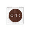 Compact cream bronzer in a dark nude shade with a shiny finish in a transparent case