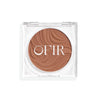 Compact cream bronzer in a light nude shade with a shiny finish in a transparent case