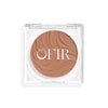 Compact cream bronzer in a fair nude shade with a shiny finish in a transparent case