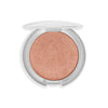 A sleek round compact featuring a shimmering peach highlighter with a smooth, metallic finish.
