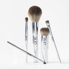 Five OFIR makeup brushes with chrome handles arranged upright on white background