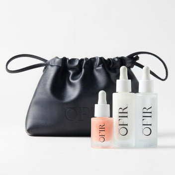 OFIR'S Skincare Bundle. Three OFIR skincare serums (Face Milk, Barrier Drops, and Bloom Serum in peony)with a black pouch displayed on white background