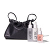 black drawstring bag with three skincare dropper bottles labeled "OFIR".
