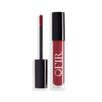 A sleek, black-capped tube of a wine shade liquid lipstick is shown alongside its applicator wand