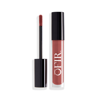 A sleek, black-capped tube of soft brown liquid lipstick is shown alongside its applicator wand