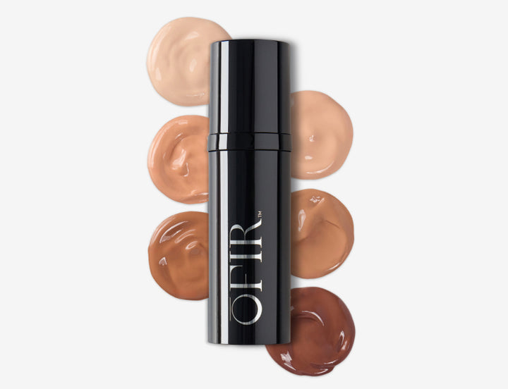 foundation stick surrounded by swatches in six nude and deep skin tone shades on a white background.