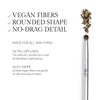 Makeup brush featuring vegan fibers and a rounded shape, designed for precise blending and a smooth application for all skin types.