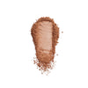 Matte brown pressed powder with a smooth texture, scattered against a white background.