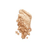 Shimmering gold pressed powder, partially crushed, showcasing fine texture and luminous finish.