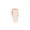 Beige crushed powder makeup swatch with a smooth center and textured edges