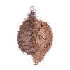 Two shades of crushed powder makeup arranged side by side, showcasing a dark brown on the left and a lighter brown on the right, with a textured, flaky appearance.
