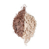 Two shades of crushed powder makeup in brown and beige, artistically arranged on a white background.