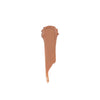 Medium dark nude cream makeup swatch with a smooth, glossy texture