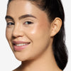 Model showcasing a warm cooper shade of highlighter/blush