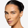Model showcasing a natural but enhance brown brow design and color in a radiant natural makeup look.