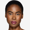 Full face make up look showcasing a rich berry pink lip gloss