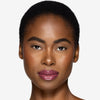 Full face make up look showcasing a rich berry pink lip gloss
