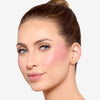 Model showcasing a deep magenta blush pigmentation in a radiant natural makeup look.