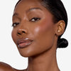 Model showcasing a light pink blush pigmentation in a radiant natural makeup look.