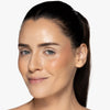 Model showcasing a deep berry blush pigmentation in a radiant natural makeup look.