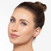 Model showcasing a very light bronze makeup pigmentation 