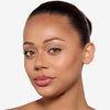 Model showcasing a medium to dark bronze makeup pigmentation 