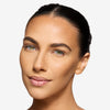 Model showcasing a medium to light bronze makeup pigmentation 