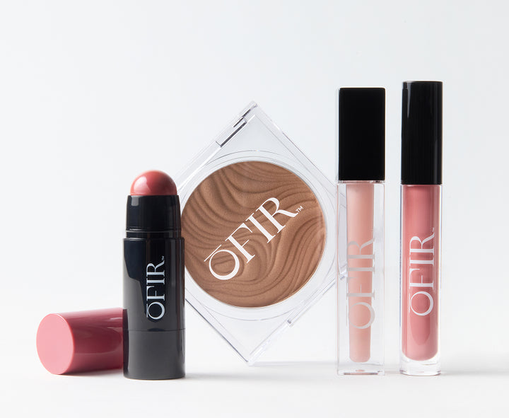 OFIR makeup collection including blush stick, bronzer compact, and two lip glosses in nude and pink shades