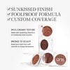 Promotional image for a cream bronzer. Text highlights product benefits: 'Sunkissed Finish' 'Foolproof Formula' & 'Custom Coverage'. Below text reads "Rich, Creamy Texture. Melts with soothing Vitamin E to moisturize and nourish" and "Bronze to Sculpt. Build your look from soft warmth to sharp dimension"