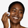 Model holding and showcasing a makeup sponge