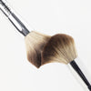 Close-up of two fluffy powder brushes