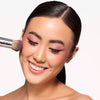 Model holding a medium and densely packed brush, showcasing a controlled blending brush