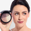 Woman holding a compact with dual-toned face powder, highlighting smooth complexion and subtle makeup finish.