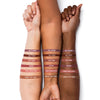 Three arms with different skin tones displaying lip liner swatches labeled: "Go There!", "All That", "Off Pink", "Berry", "Pink Smoothie" and "What-Eh-Ver!"