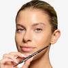 Model holding and showcasing a blond brow liner
